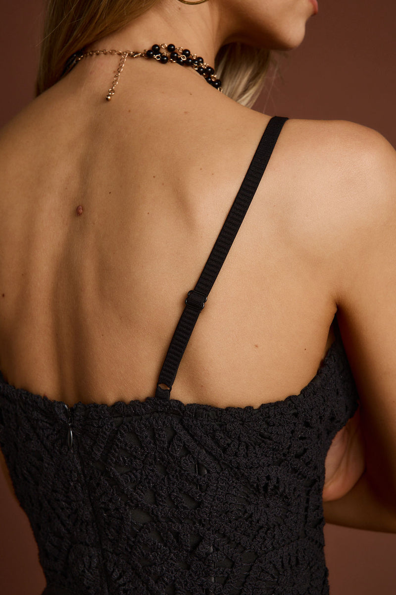 Detail shot of the Finnley Black Crochet Fringe Mini Dress highlighting the fringe and crochet elements.