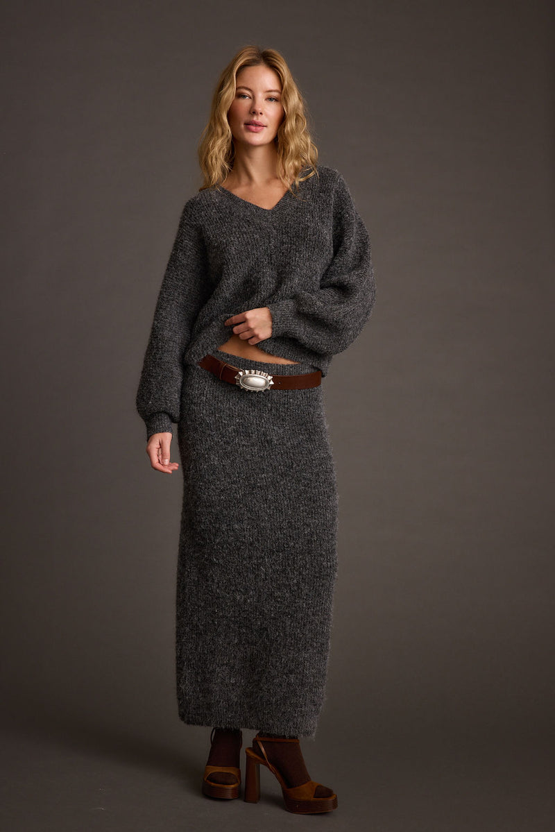 Full-length view of the sweater showing the drape and movement.