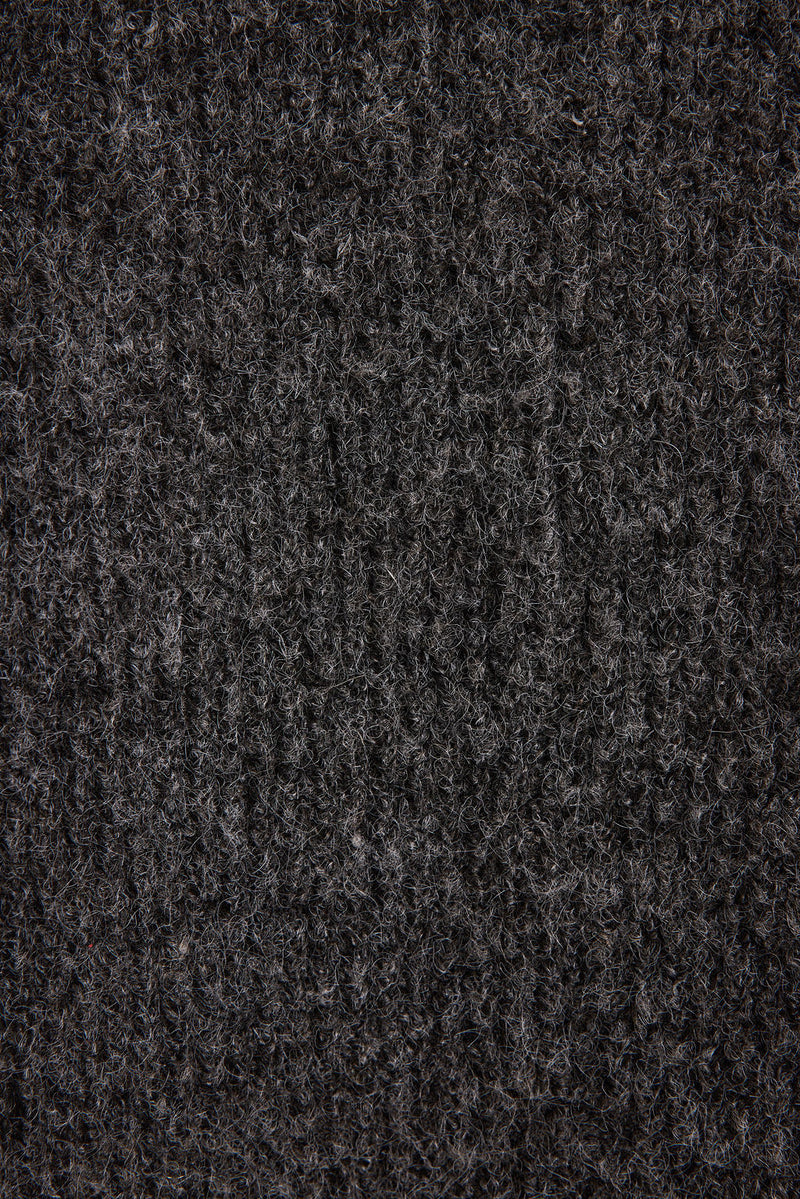Lifestyle shot of the sweater styled for day-to-night versatility.