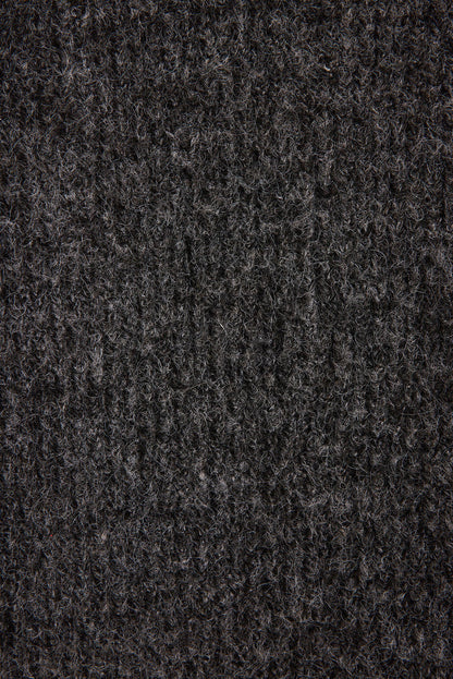 Lifestyle shot of the sweater styled for day-to-night versatility.