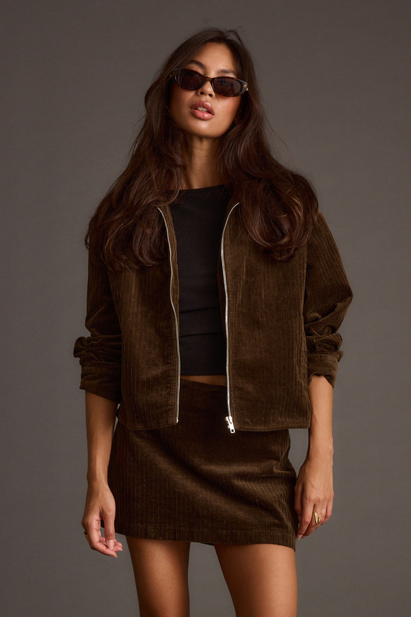 Full-length view of the mocha jacket showing the drape and movement.
