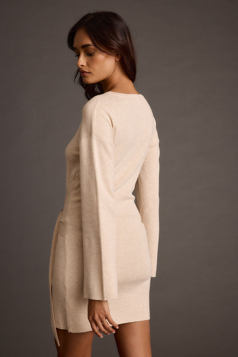 Back view of the cream mini dress showing the silhouette and fit.