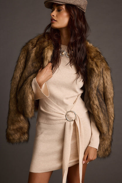 Full-length view of the cream mini dress showing the drape and movement.
