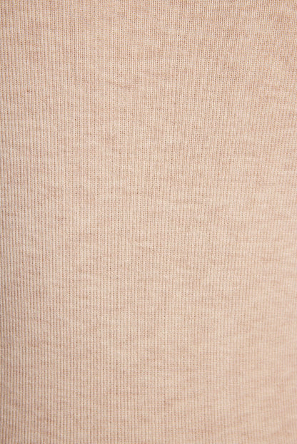 Lifestyle shot of the cream mini dress styled for day-to-night versatility.