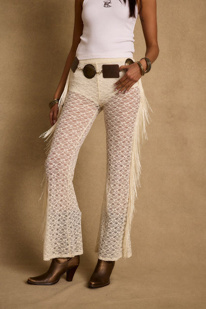 Full-length view of the cream pants showing the drape and movement.