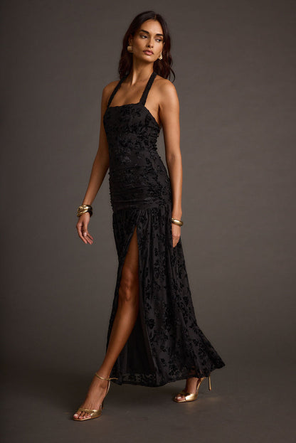 Black halter maxi dress with elegant accents, a vacation maxi dress essential.