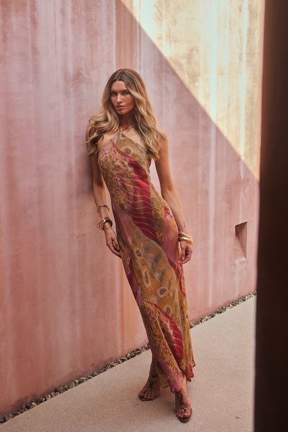 Model wearing the 12th Tribe Isabella Patchwork Maxi Dress, a halter tie-back maxi dress in a sheer, lightweight bias-cut chiffon with patchwork detailing and back neckline gripper tape, perfect for summer soirées, festival-ready looks, and effortless vacation styling