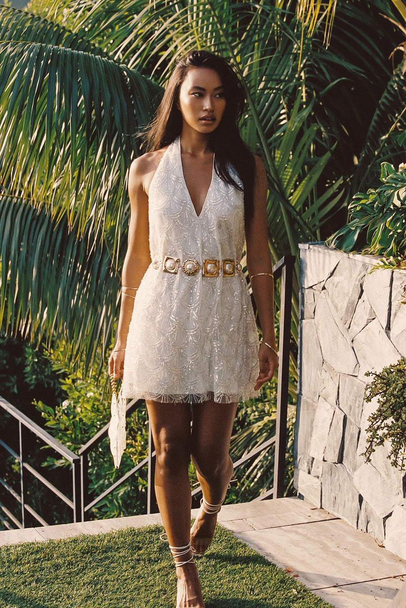 Close-up of the Izzie White Beaded Mini Dress showcasing the beaded texture and craftsmanship.