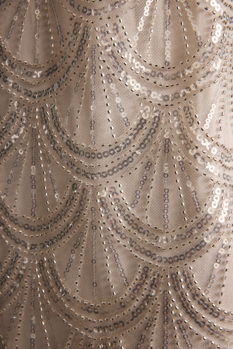 Izzie White Beaded Mini Dress paired with complementary accessories for a polished look.