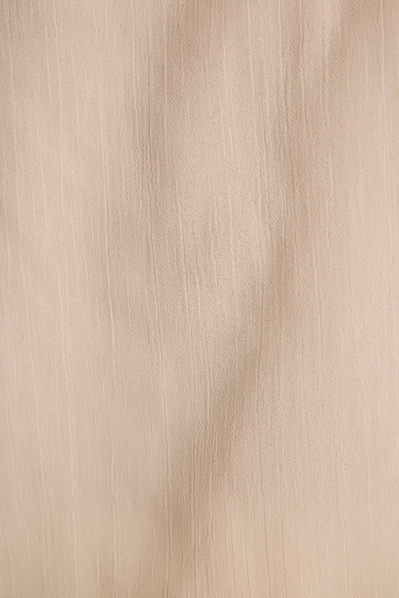 Close-up of ivory crinkle-textured sheer fabric used in the Jada halter top.