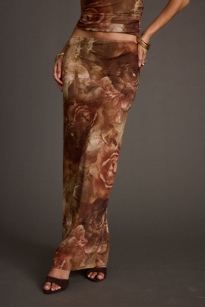 Full-length view of the floral maxi skirt showing the drape and movement.