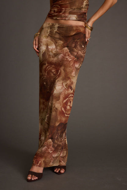 Full-length view of the floral maxi skirt showing the drape and movement.