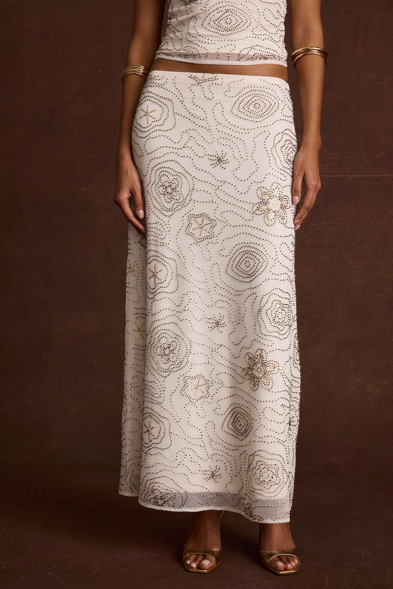 Lifestyle shot of the white maxi skirt styled for day-to-night versatility.