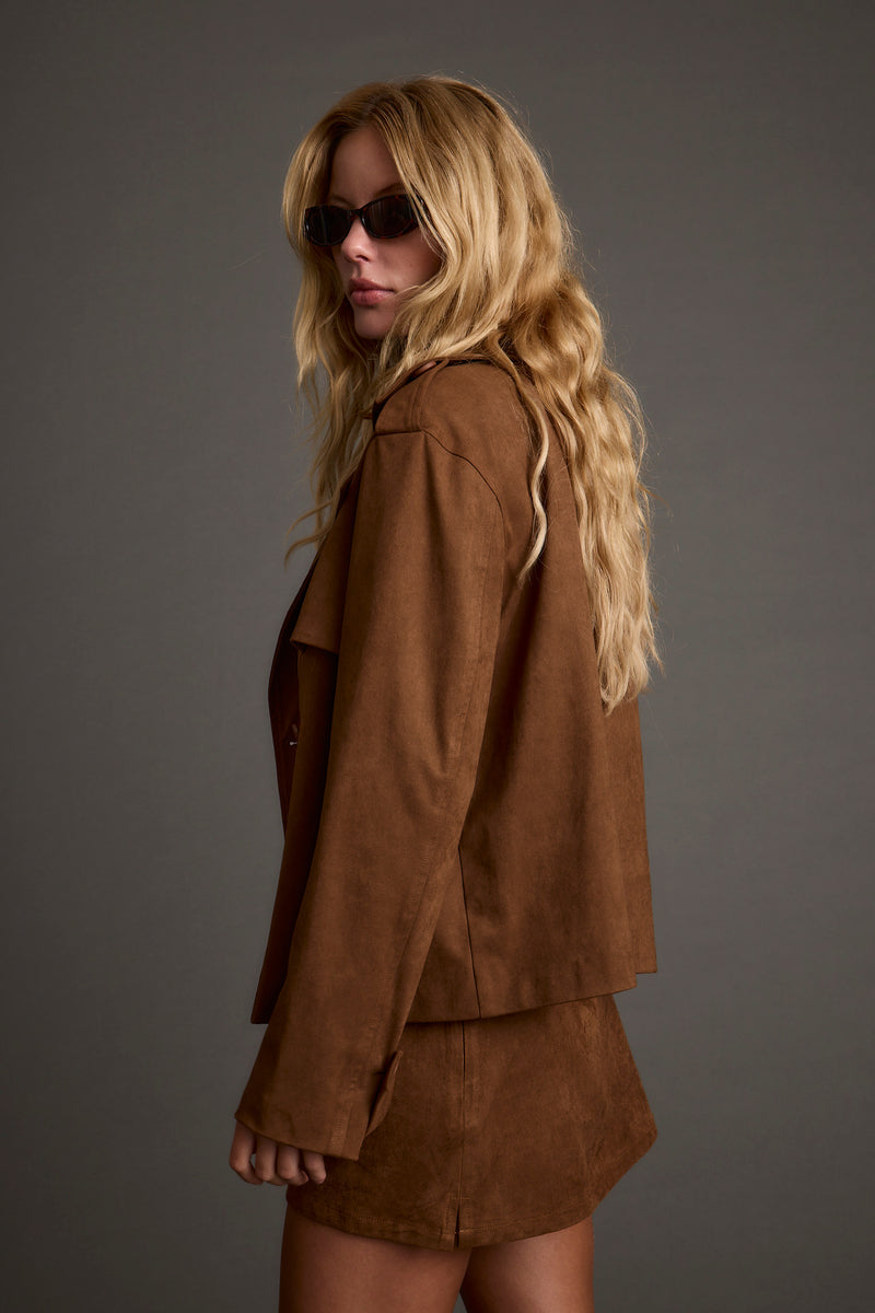 Back view of the cognac jacket showing the silhouette and fit.