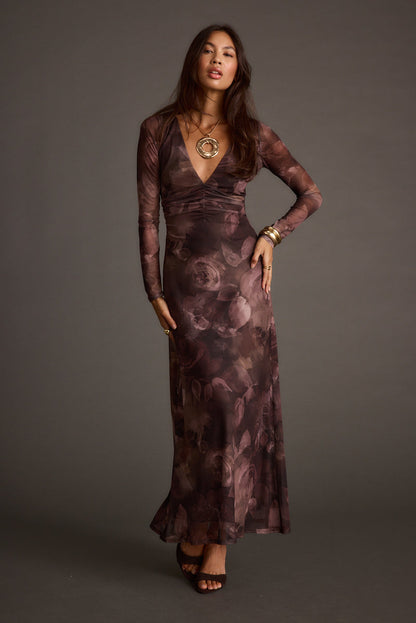 Full-length view of the plum maxi dress showing the drape and movement.