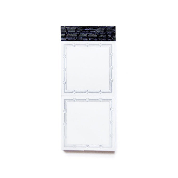 a packet of book labels with two perforated labels per sheet