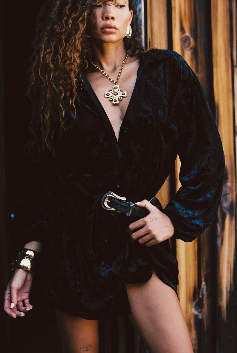 Back view of the black velvet mini dress showing the silhouette and fit.