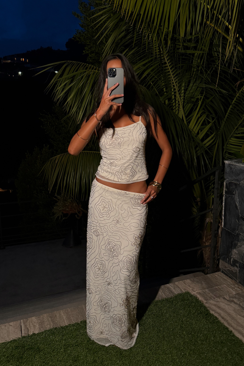 Luci White Beaded Tank paired with complementary accessories for a polished look.
