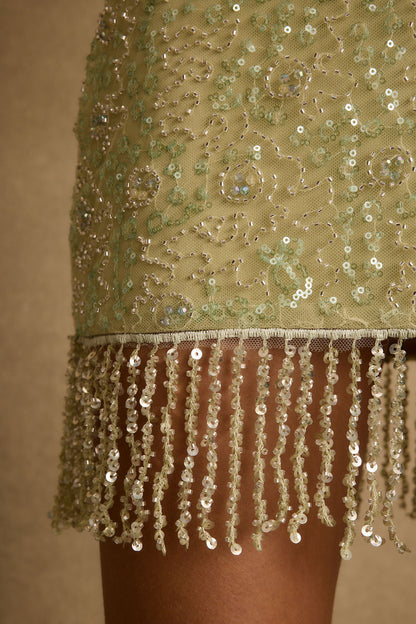 Lifestyle shot of the sage mini skirt styled for day-to-night versatility.