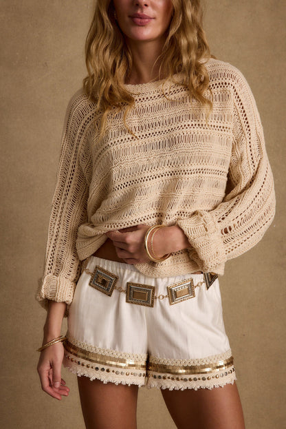 Cream crochet sweater with refined detailing and a flattering silhouette.