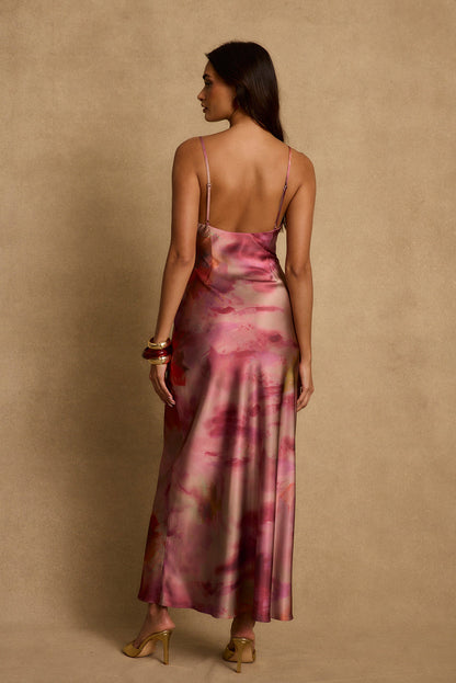 Back view of berry floral satin maxi dress with adjustable spaghetti straps and gold heels.