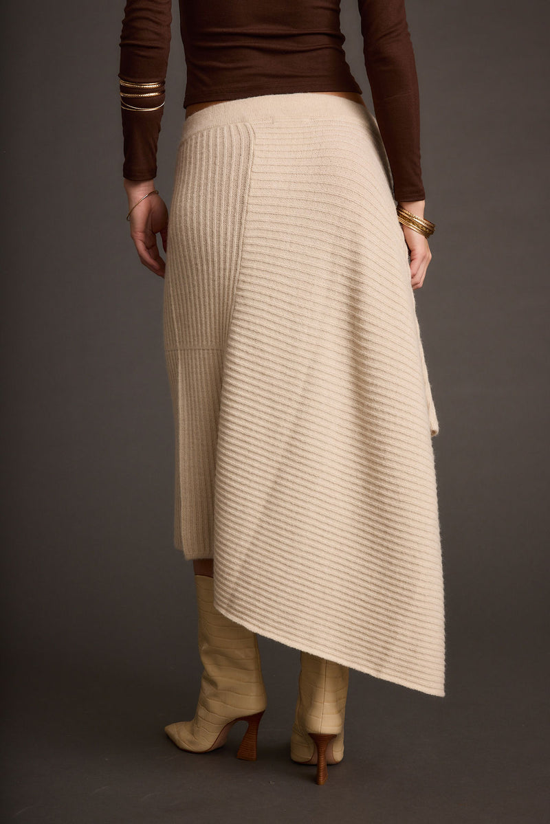 Close-up of the Mod Cream Asymmetrical Skirt showcasing the fabric texture and design details.