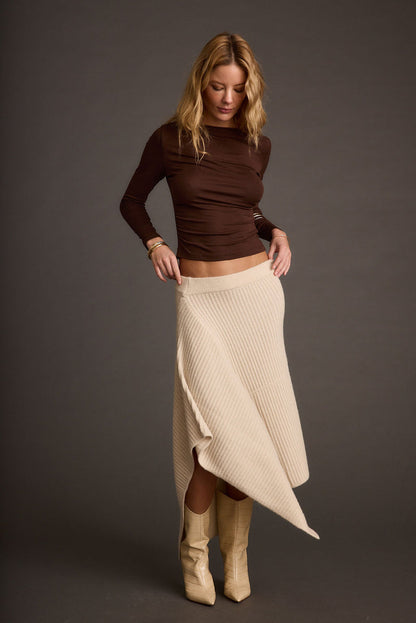 Full-length view of the cream skirt showing the drape and movement.
