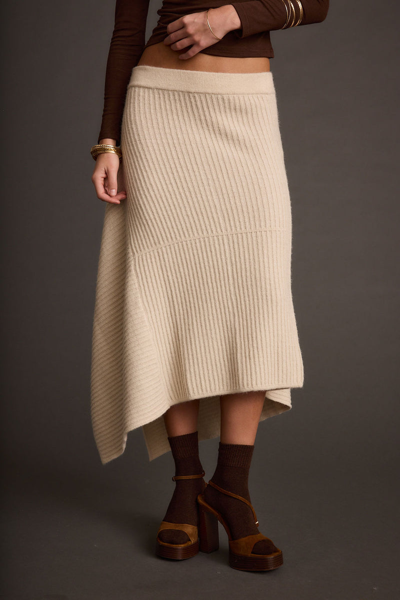 Detail shot of the Mod Cream Asymmetrical Skirt highlighting the design elements.
