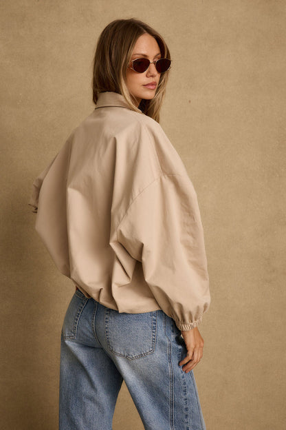 Back view of the khaki jacket showing the silhouette and fit.