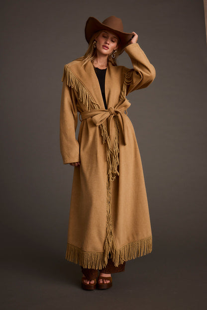 Back view of the camel fringe jacket showing the silhouette and fit.