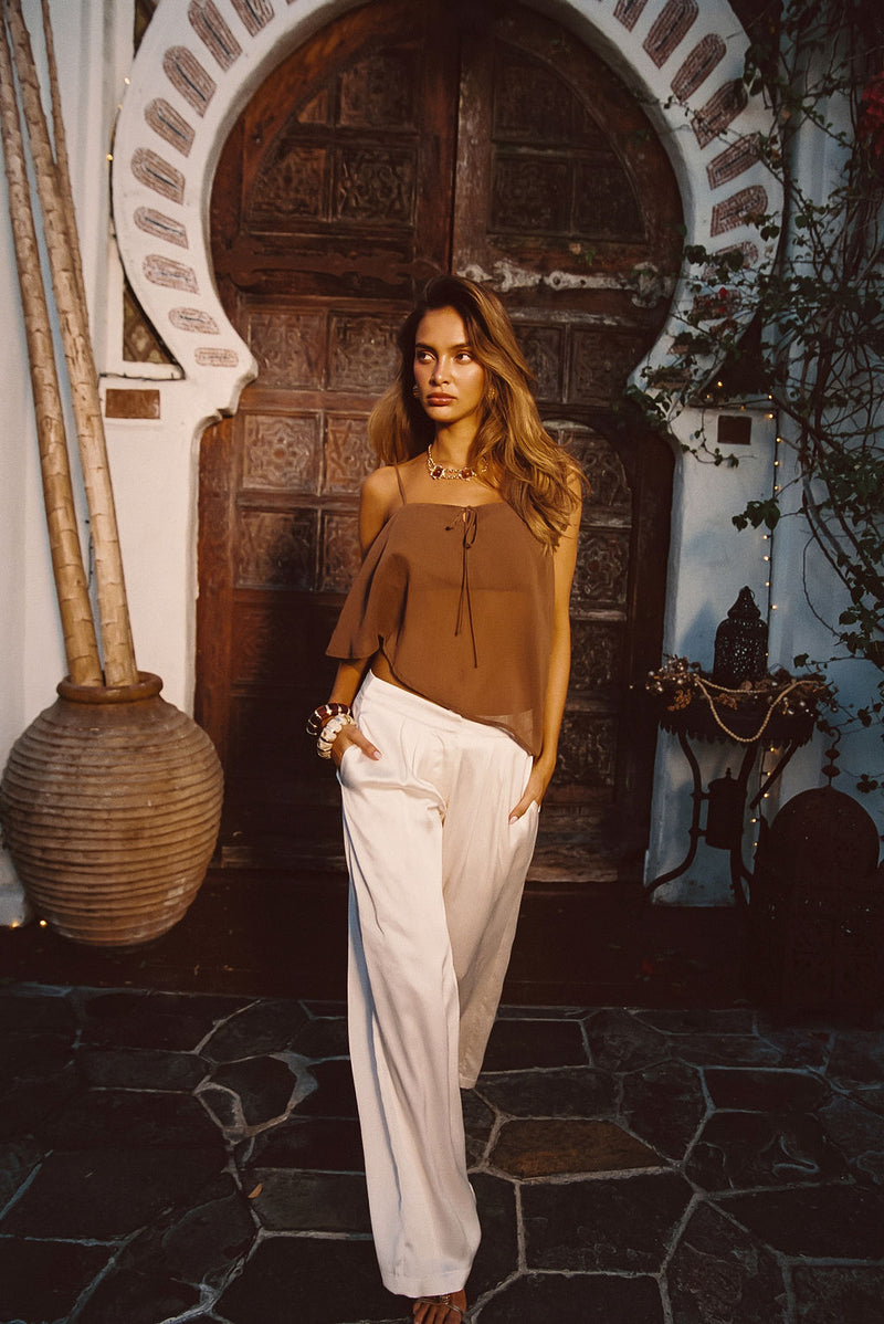 Cream satin trousers with refined accents, a cream satin pants standout.