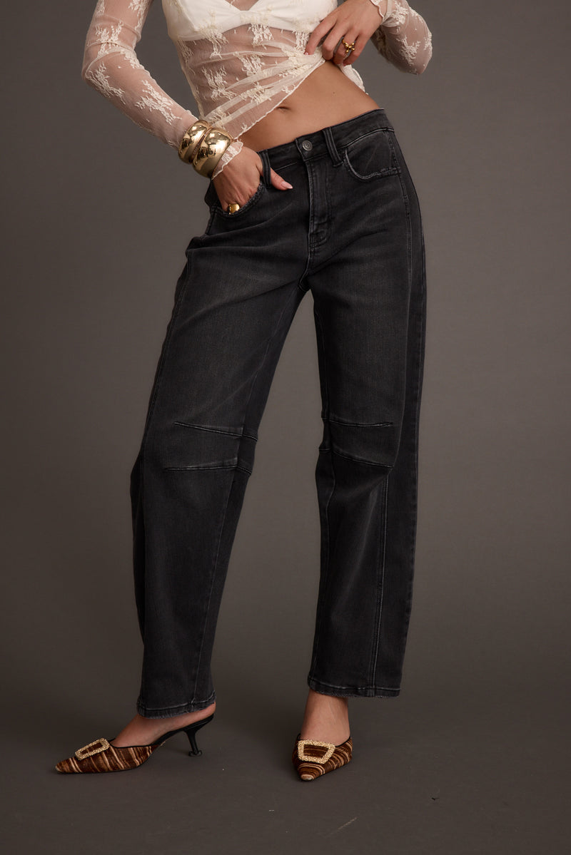 Black denim jeans with refined detailing and a flattering silhouette.