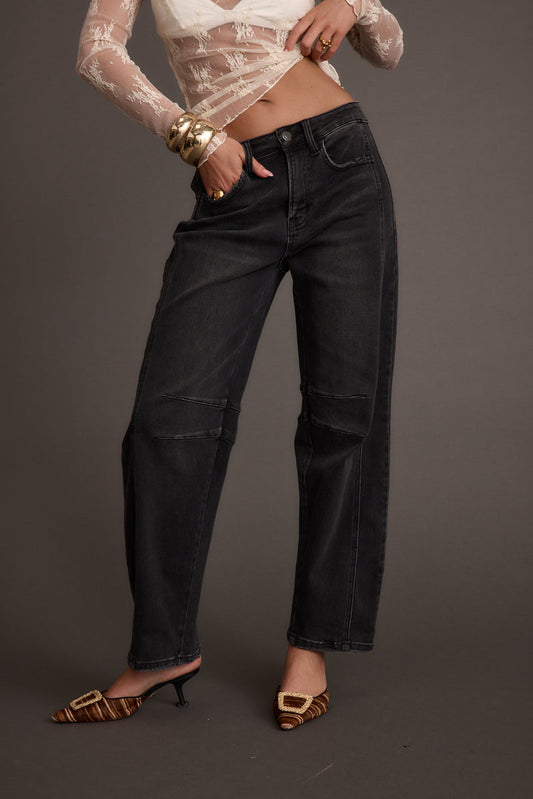 Black denim jeans with refined detailing and a flattering silhouette.
