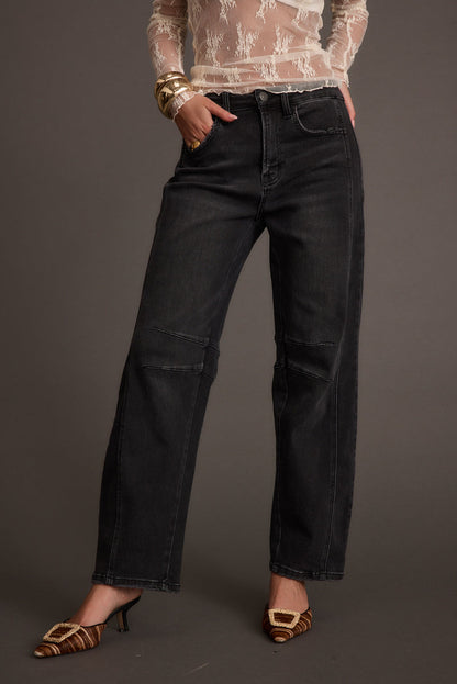 Full-length view of the black jeans showing the drape and movement.