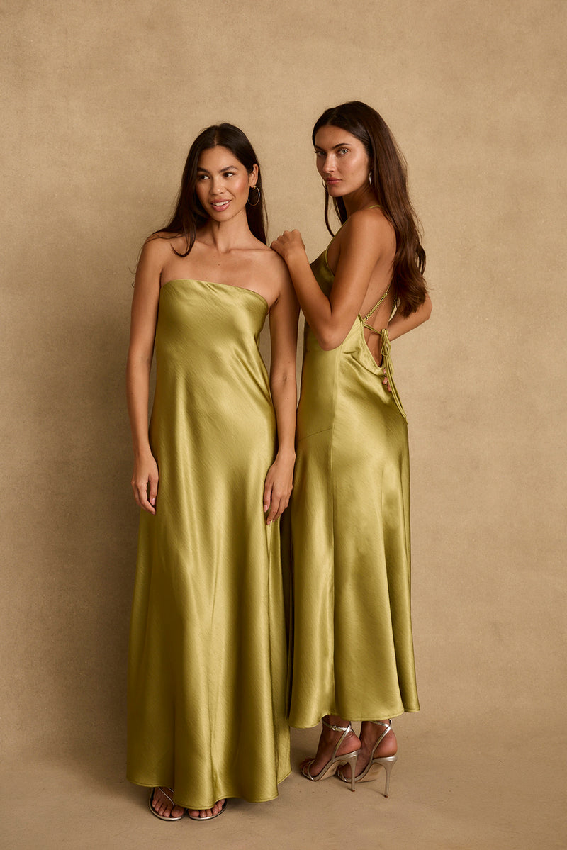 Two women model the Natalia chartreuse satin maxi dress, front and open-back views.