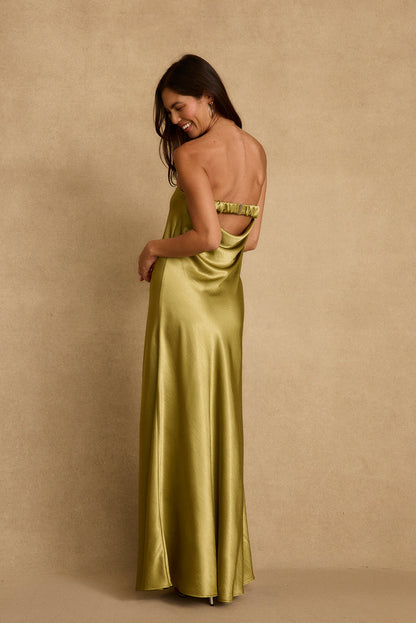 Back view of chartreuse satin strapless maxi dress with open back and gripper band.