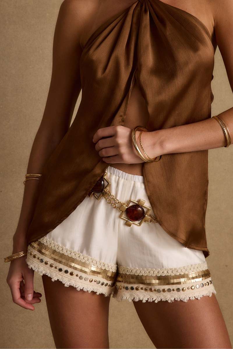 Gold shorts with elegant accents, a festival shorts standout.