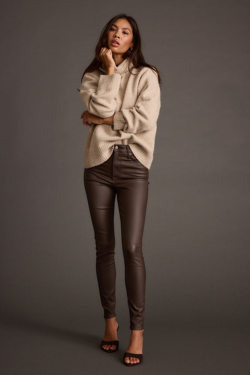 Lifestyle shot of the mocha pants styled for day-to-night versatility.