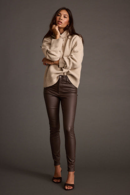 Lifestyle shot of the mocha pants styled for day-to-night versatility.