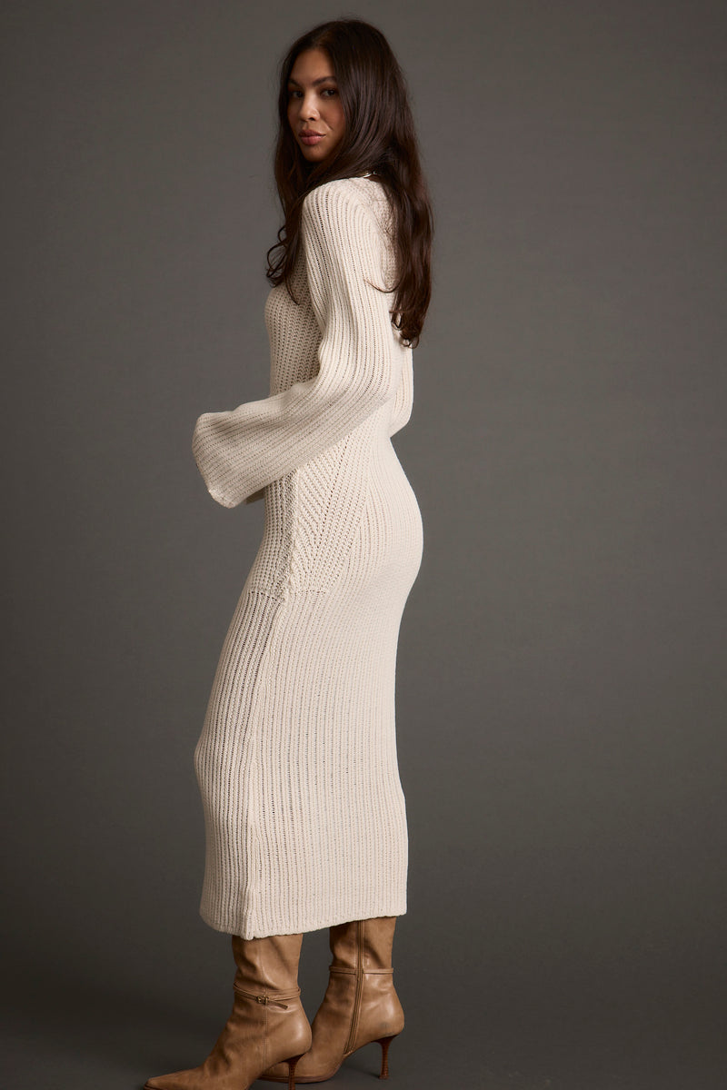 Close-up of the Nolita Cream Midi Sweater Dress showcasing the fabric texture and design details.