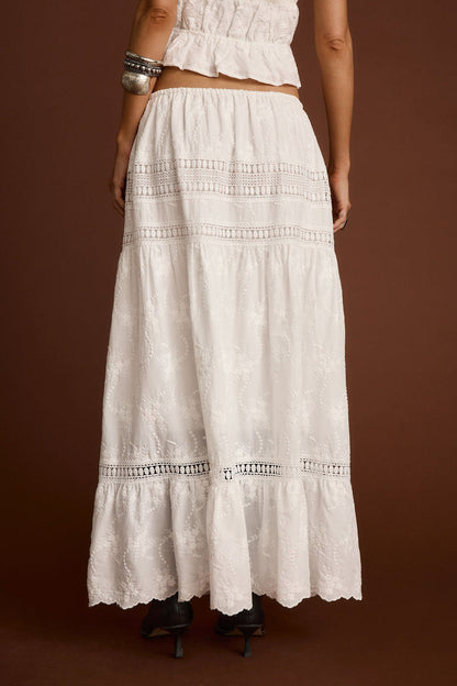 Back view of the white embroidered maxi skirt showing the silhouette and fit.