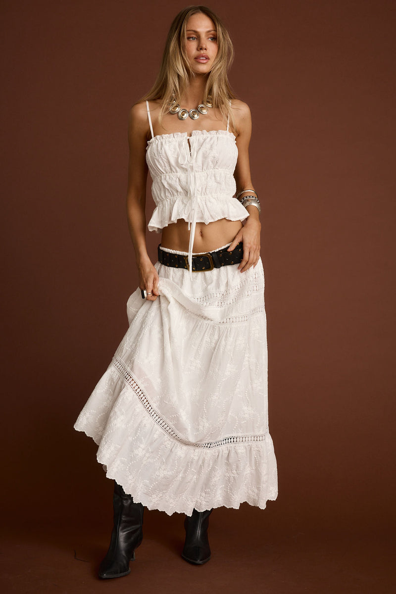 Close-up of the Nomad White Embroidered Maxi Skirt showcasing the embroidered texture and craftsmanship.