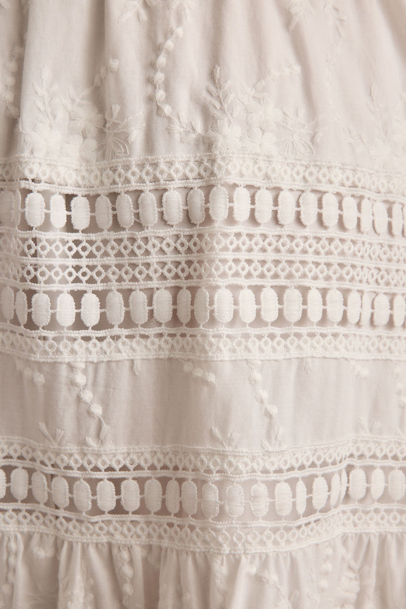 Lifestyle shot of the white maxi skirt styled for day-to-night versatility.