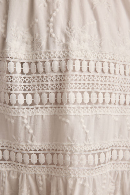 Lifestyle shot of the white maxi skirt styled for day-to-night versatility.
