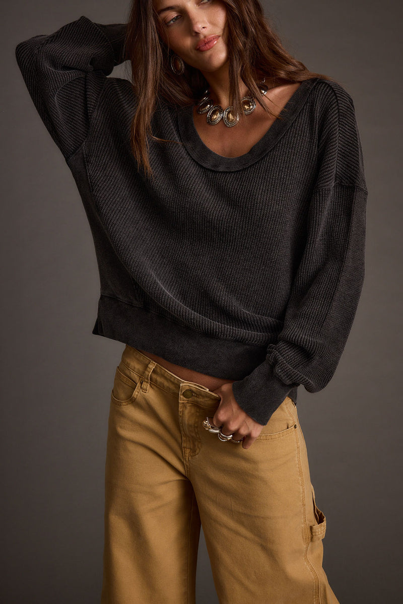 Black knit top with knit accents, a black fringe top essential.