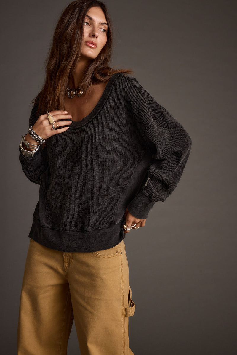 Full-length view of the black top showing the drape and movement.