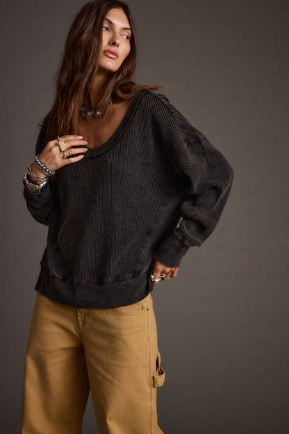 Full-length view of the black top showing the drape and movement.