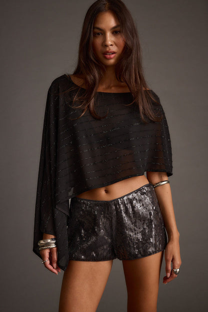 Full-length view of the black piece showing the drape and movement.