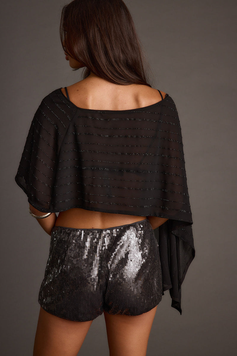 Lifestyle shot of the black piece styled for day-to-night versatility.