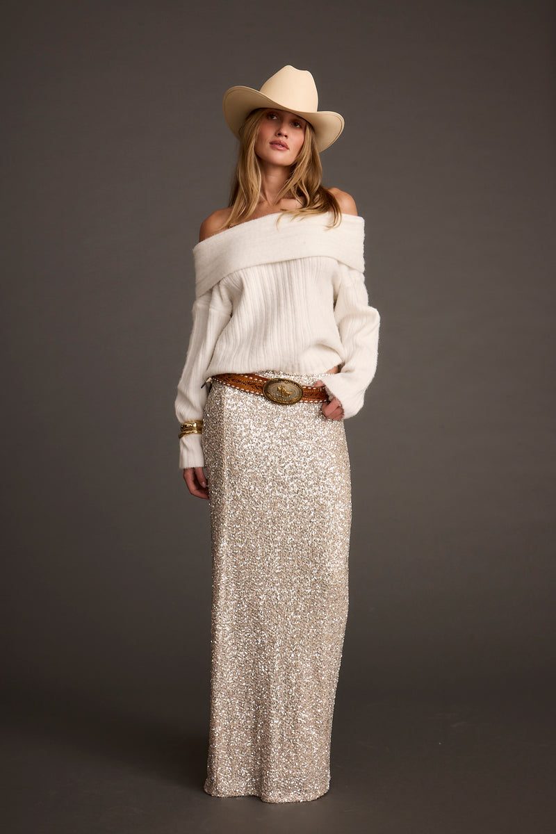 Back view of the ivory sweater showing the silhouette and fit.
